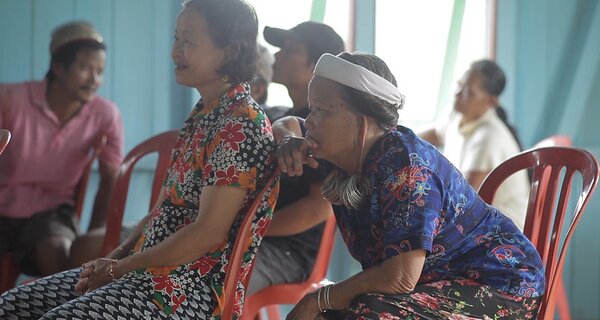 Inui Yeq listens intently during a public consultation with the Dayak Bahau of Long Isun