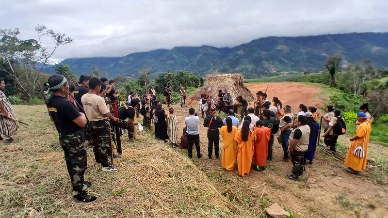 A group of people stand on a hill at a meeting in Peru on Indigenous Amazonian Security