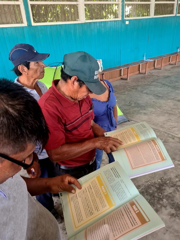 Men looking at a book 